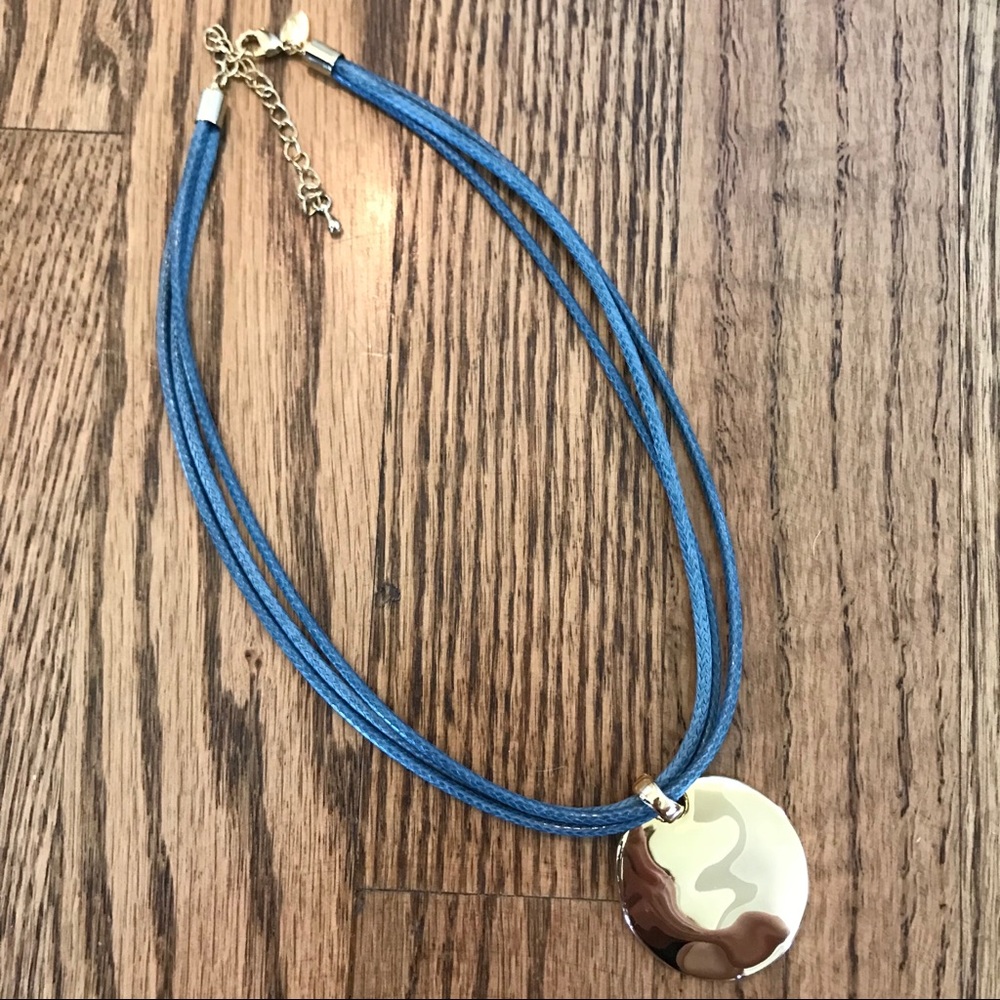 Gold pendant/blue leather necklace